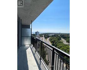 A balcony with a view of a highway and buildings.