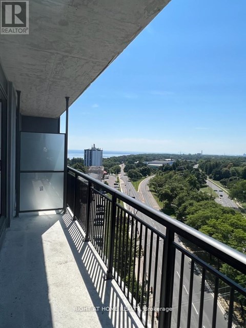 A balcony with a view of a highway and buildings.