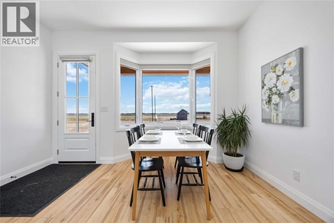A dining room with a table set for four.