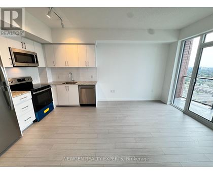 A kitchen with white cabinets and a microwave above the stove.