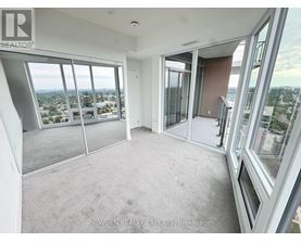 A spacious room with large windows overlooking a cityscape.