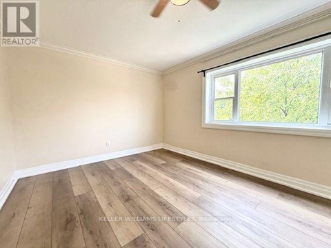 A room with a window and a ceiling fan.