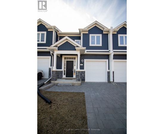 A modern house with a dark blue exterior and white trim.
