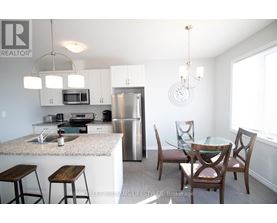 A kitchen with a table and chairs.