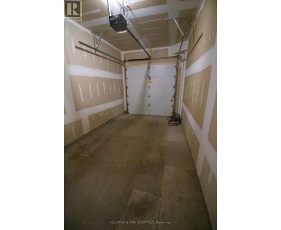 A spacious garage with a concrete floor and white walls.