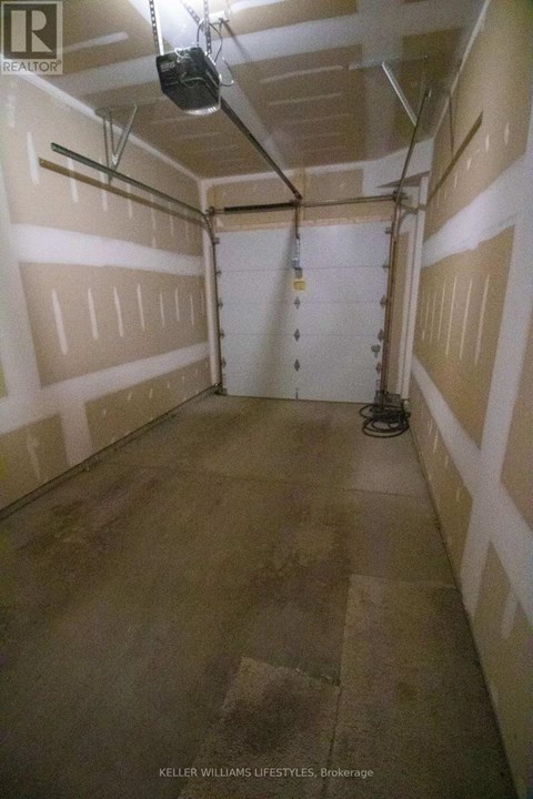 A spacious garage with a concrete floor and white walls.