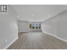 A spacious room with a view of the outside through the window.