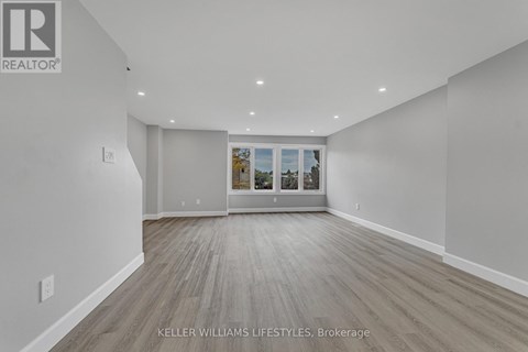 A spacious room with a view of the outside through the window.