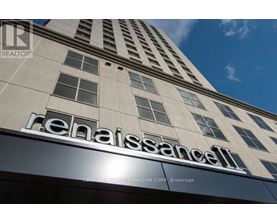 A tall building with the name Renaissance on it.