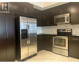 A kitchen with a stainless steel refrigerator and oven.