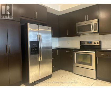 A kitchen with a stainless steel refrigerator and oven.