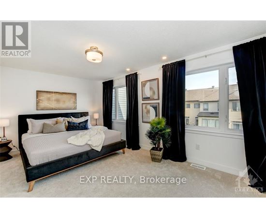 A bedroom with a large bed and a view of the city.