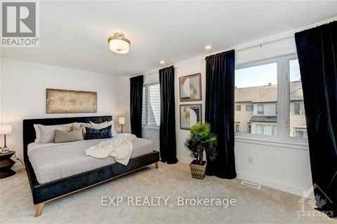 A bedroom with a large bed and a view of the city.