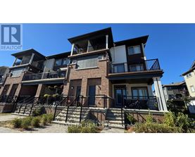 A multi-story residential building with balconies and a clear blue sky.