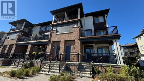 A multi-story residential building with balconies and a clear blue sky.