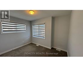 A room with a window and a sign that says FIDACITY REALTY, Brokerage.