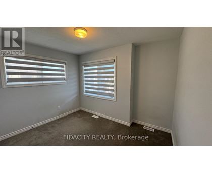 A room with a window and a sign that says FIDACITY REALTY, Brokerage.