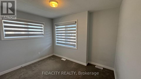 A room with a window and a sign that says FIDACITY REALTY, Brokerage.