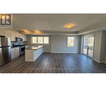 A well-lit kitchen with stainless steel appliances and a large island.