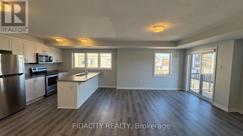 A well-lit kitchen with stainless steel appliances and a large island.