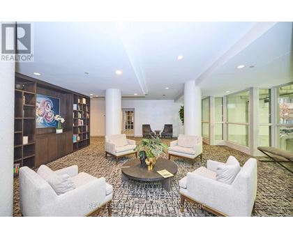 A living room with a large rug and a coffee table.