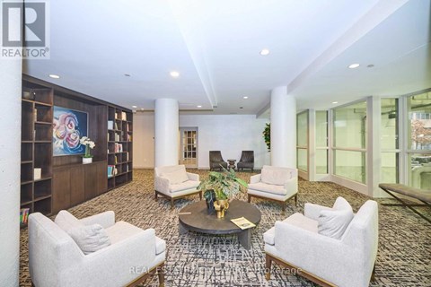 A living room with a large rug and a coffee table.
