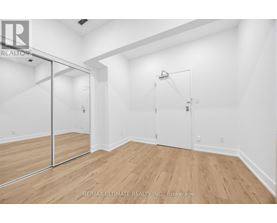 A room with a sliding door and wood flooring.
