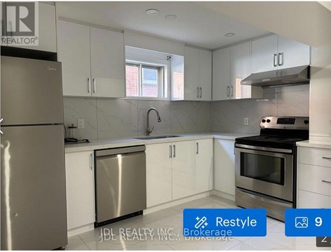 A modern kitchen with stainless steel appliances and white cabinets.
