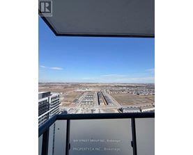 A view from a high-rise building looking out over a large, empty parking lot.