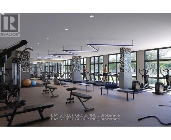 A gym with a variety of equipment including weights and benches.