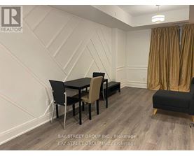 A dining room with a table set for four.