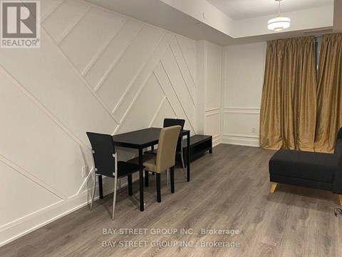 A dining room with a table set for four.