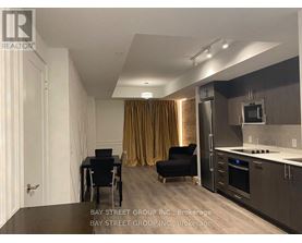 A modern kitchen with a dining table and chairs.