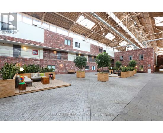 A large open space with brick walls and wooden beams on the ceiling.