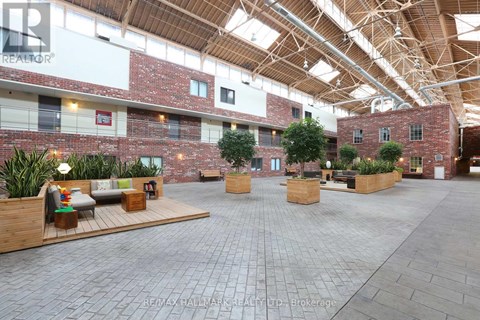 A large open space with brick walls and wooden beams on the ceiling.