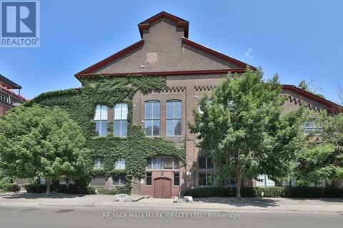 A building with a red roof and ivy growing on it.