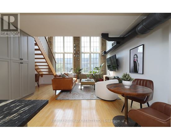 A living room with a brown leather chair and a wooden table.