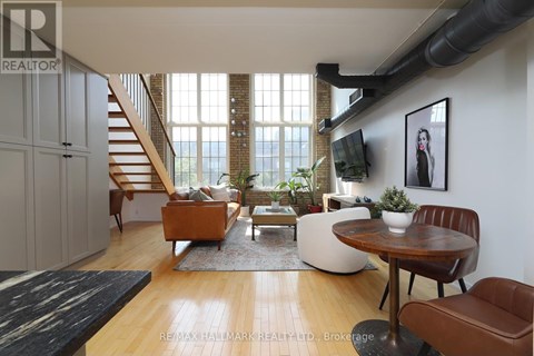 A living room with a brown leather chair and a wooden table.