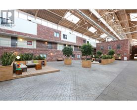A large open space with brick walls and wooden beams on the ceiling.