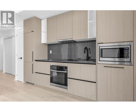 A modern kitchen with wooden cabinets and stainless steel appliances.
