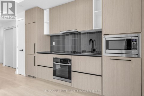 A modern kitchen with wooden cabinets and stainless steel appliances.
