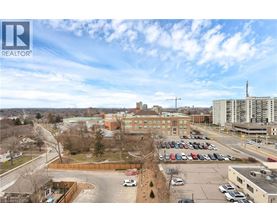 A parking lot with cars and a building in the background.