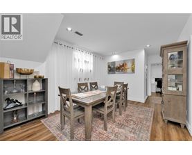 A dining room with a wooden table and chairs.