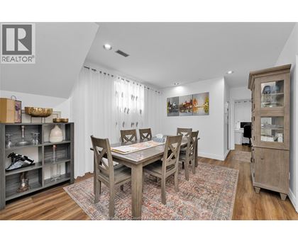 A dining room with a wooden table and chairs.