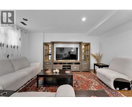 A living room with a grey couch, a black coffee table, and a television.