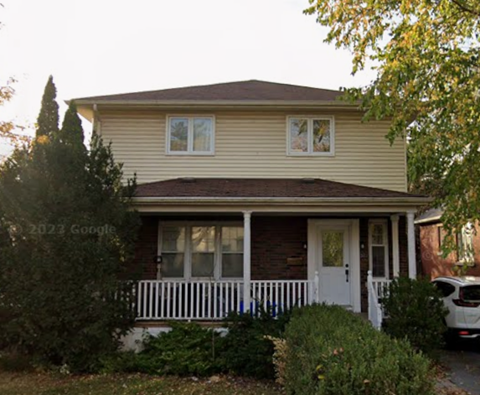 A house with a white door and a small porch.