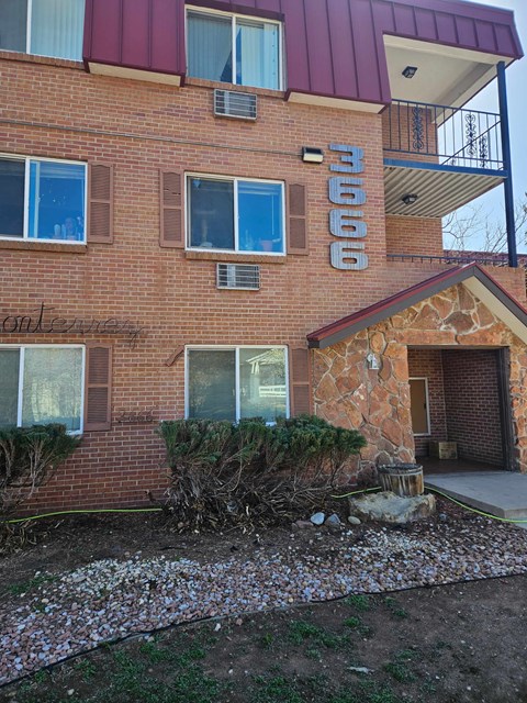 A red brick building with the number 3066 on it.