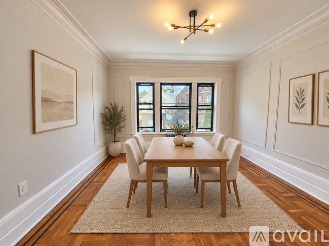 A dining room with a wooden table and chairs.