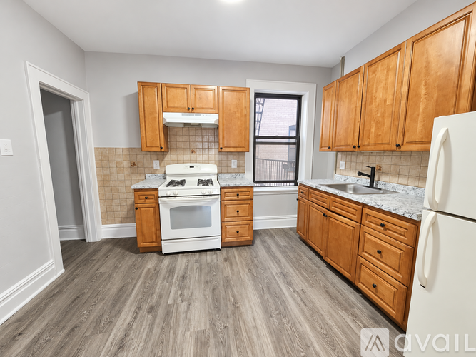 A kitchen with wooden cabinets and a white refrigerator.