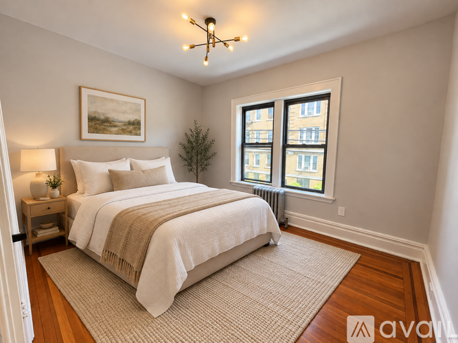 A bedroom with a large bed and a painting on the wall.